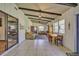 Bright living room with beamed ceiling, tile floors, and sliding glass doors to the exterior at 9415 Cat Track Trl, Lake Wales, FL 33898