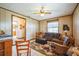 Spacious living room showcasing the wall decor, wood-paneled walls, and tile flooring at 9415 Cat Track Trl, Lake Wales, FL 33898