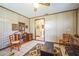 A living room with a ceiling fan, wood-paneled walls, and tile flooring throughout at 9415 Cat Track Trl, Lake Wales, FL 33898