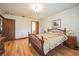 Comfortable main bedroom with wood floors and ensuite bathroom at 9415 Cat Track Trl, Lake Wales, FL 33898