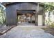Large metal outbuilding has concrete floor, high ceiling, shelves, and large garage door at 9415 Cat Track Trl, Lake Wales, FL 33898
