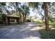 Multiple outbuildings include enclosed garages, open garages, and sheds with room for cars and equipment at 9415 Cat Track Trl, Lake Wales, FL 33898