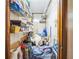 A cluttered walk-in closet with wood-paneled walls and wire shelving at 9415 Cat Track Trl, Lake Wales, FL 33898
