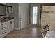 Bathroom featuring dual sinks, a soaking tub, granite countertops and travertine tile at 2691 Cedaridge Cir, Clermont, FL 34711