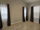 Bright and airy bedroom boasts tile floors and an abundance of natural light at 2691 Cedaridge Cir, Clermont, FL 34711