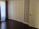 Bedroom featuring dark hardwood floors, natural light, and a neutral color scheme at 2691 Cedaridge Cir, Clermont, FL 34711