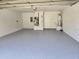 Spacious garage with epoxy flooring, white walls, and utility connections at 2691 Cedaridge Cir, Clermont, FL 34711