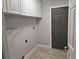 Bright laundry room featuring ample white cabinets and a neutral color scheme at 2691 Cedaridge Cir, Clermont, FL 34711