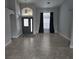 Open living area featuring tile floors, a stylish pendant light, and large windows at 2691 Cedaridge Cir, Clermont, FL 34711