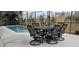 The refreshing in-ground pool has an outdoor seating area with a table under an umbrella at 2691 Cedaridge Cir, Clermont, FL 34711