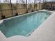 Relaxing in-ground pool featuring a screen enclosure and a paved deck at 2691 Cedaridge Cir, Clermont, FL 34711
