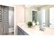 Well-lit bathroom with double vanity, quartz countertops, and shower with patterned curtain at 5103 Bridgehaven Rd, Davenport, FL 33837