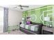 A bedroom features a custom-painted wall, a daybed, and decor with sports themed elements at 5103 Bridgehaven Rd, Davenport, FL 33837