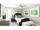Comfortable bedroom with a dark tufted headboard, white linens, and stylish green accents with natural lighting at 5103 Bridgehaven Rd, Davenport, FL 33837