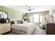 Serene bedroom featuring a decorative cabinet, natural textures, and a neutral color palette at 5103 Bridgehaven Rd, Davenport, FL 33837