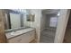Bathroom featuring an extended vanity with a mirror, connecting to the bedroom at 6372 Raleigh St # 1911, Orlando, FL 32835