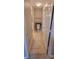 Narrow view of a bathroom featuring a toilet, sink, and door at 6372 Raleigh St # 1911, Orlando, FL 32835