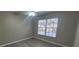 Bright bedroom with a ceiling fan, modern blinds, and wood-look flooring at 6372 Raleigh St # 1911, Orlando, FL 32835