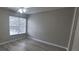 This bedroom has a light ceiling fan, light-colored walls, light blinds, and wood-style floors at 6372 Raleigh St # 1911, Orlando, FL 32835