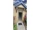 Inviting front entrance showcasing exterior lighting, neutral paint, and a clear path leading into the home at 6372 Raleigh St # 1911, Orlando, FL 32835