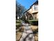 Charming exterior view of the townhome featuring lush landscaping, a private walkway, and inviting curb appeal at 6372 Raleigh St # 1911, Orlando, FL 32835