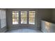 Bright and airy room featuring a large bay window with views of trees and updated flooring for modern appeal at 6372 Raleigh St # 1911, Orlando, FL 32835