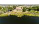Expansive aerial shot of a home situated on a lake with a dock and abundant greenery at 5020 Old Lucerne Park Rd, Winter Haven, FL 33881