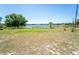 Picturesque backyard with a well-kept lawn and tranquil lake view in the background at 5020 Old Lucerne Park Rd, Winter Haven, FL 33881
