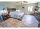 Cozy bedroom with a large bed, rustic wood furnishings, and a serene atmosphere at 5020 Old Lucerne Park Rd, Winter Haven, FL 33881