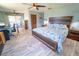 Spacious primary bedroom with a king bed, wood furniture, desk, and sliding glass doors at 5020 Old Lucerne Park Rd, Winter Haven, FL 33881