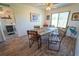 Bright dining room featuring rustic wooden table with seating for six, ceiling fan, and decor at 5020 Old Lucerne Park Rd, Winter Haven, FL 33881