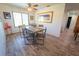 Bright dining room featuring a rustic dining table and large window offering plenty of natural light at 5020 Old Lucerne Park Rd, Winter Haven, FL 33881