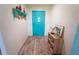 Inviting entryway featuring a bright turquoise front door and stylish decor at 5020 Old Lucerne Park Rd, Winter Haven, FL 33881