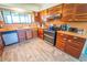 Spacious kitchen features custom wood cabinetry, tile countertops, and stainless steel appliances at 5020 Old Lucerne Park Rd, Winter Haven, FL 33881