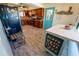 Well-appointed kitchen with custom wood cabinets, stainless steel refrigerator, and bright turquoise door at 5020 Old Lucerne Park Rd, Winter Haven, FL 33881