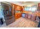 Charming kitchen showcasing wood cabinets, stainless steel refrigerator and a view of lake at 5020 Old Lucerne Park Rd, Winter Haven, FL 33881