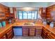 Well-lit kitchen featuring wood cabinets, tile countertops, stainless steel appliances, and water view at 5020 Old Lucerne Park Rd, Winter Haven, FL 33881