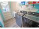 A well-organized laundry room featuring a new washer and dryer, sink, and ample storage space at 5020 Old Lucerne Park Rd, Winter Haven, FL 33881