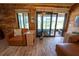 Cozy living room with wood-paneled walls and sliding glass doors offering picturesque waterfront views at 5020 Old Lucerne Park Rd, Winter Haven, FL 33881