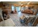 Spacious living room with wood walls, light floors, a leather sectional, and a cozy fireplace at 5020 Old Lucerne Park Rd, Winter Haven, FL 33881