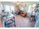 Bright home office with a large desk and a comfortable sitting area, featuring a cat tree at 5020 Old Lucerne Park Rd, Winter Haven, FL 33881