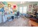 Bright home office with a large window, desk, and lots of art supplies and interesting decor at 5020 Old Lucerne Park Rd, Winter Haven, FL 33881