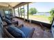 Relaxing screened porch with comfortable seating overlooking a picturesque view of the lake at 5020 Old Lucerne Park Rd, Winter Haven, FL 33881