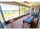 Relaxing screened porch with comfortable seating overlooking a picturesque view of the lake at 5020 Old Lucerne Park Rd, Winter Haven, FL 33881