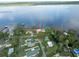 Aerial view of lakeside homes with docks and the property marked with an arrow at 830 County Rd 457, Lake Panasoffkee, FL 33538