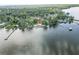 Waterfront property featuring a home with a pool and its own private access to the water at 830 County Rd 457, Lake Panasoffkee, FL 33538