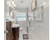 Bright bathroom featuring white marble tiling and a sleek vanity sink at 830 County Rd 457, Lake Panasoffkee, FL 33538