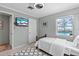 Cozy bedroom featuring a view of the pool and a mounted TV at 830 County Rd 457, Lake Panasoffkee, FL 33538