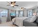 Comfortable bedroom featuring serene lake views, modern ceiling fans, and stylish decor at 830 County Rd 457, Lake Panasoffkee, FL 33538