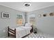 Neutral bedroom with lots of natural light from two windows and a ceiling fan at 830 County Rd 457, Lake Panasoffkee, FL 33538